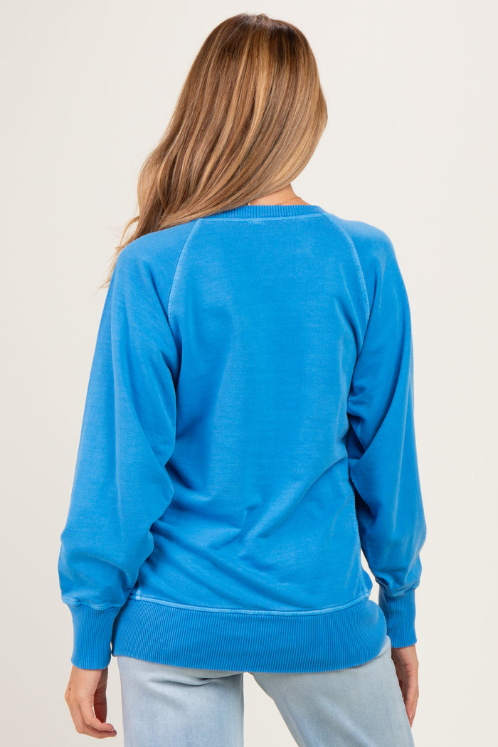 woman wearing a blue maternity sweatshirt with a relaxed fit and ribbed hem, showing the back view