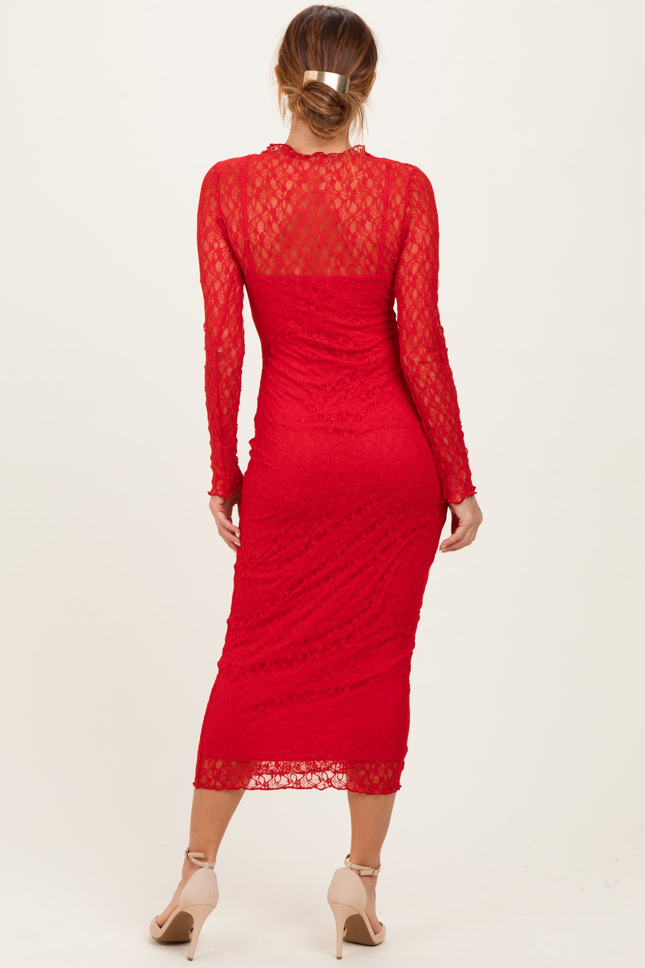 woman wearing a red long sleeve lace dress with a midi length and fitted silhouette