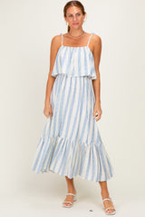 woman wearing a white and blue striped midi dress with ruffled hem and adjustable straps