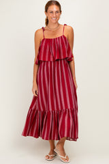 woman wearing a red and white striped maxi dress with ruffled sleeves and a flowing skirt