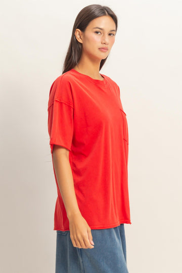 woman wearing a bright red oversized t-shirt with a pocket in a casual style