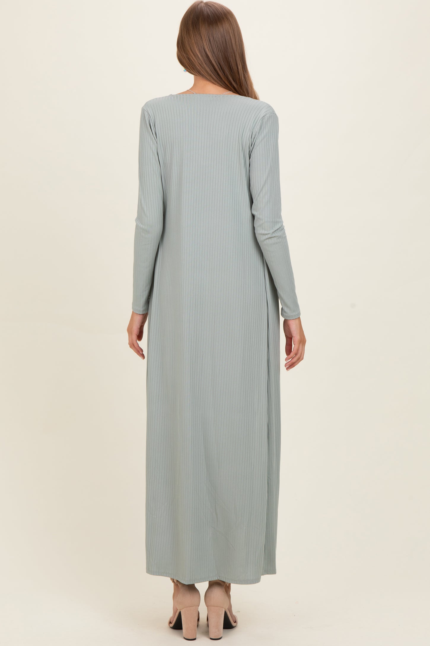woman wearing a light green long sleeve maternity maxi dress, showing a smooth, flowing silhouette from the back