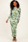 woman wearing a long sleeve green floral maxi dress with a fitted silhouette and a sheer overlay
