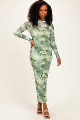 woman wearing a long sleeve green floral maxi dress with a fitted silhouette and side slits