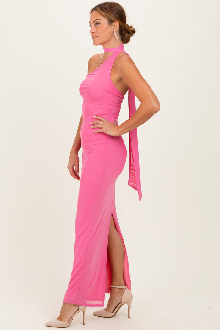 woman wearing a hot pink halter neck gown with a side slit and a flowing back tie detail