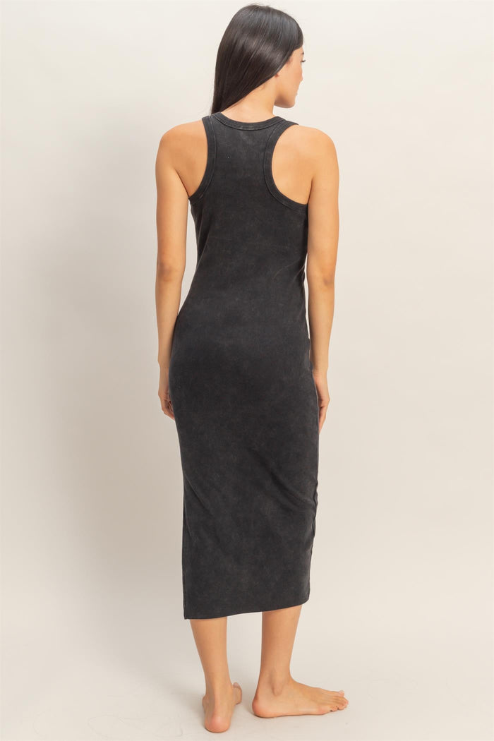 woman wearing a black ribbed midi tank dress, showing the back view and styled with a fitted silhouette