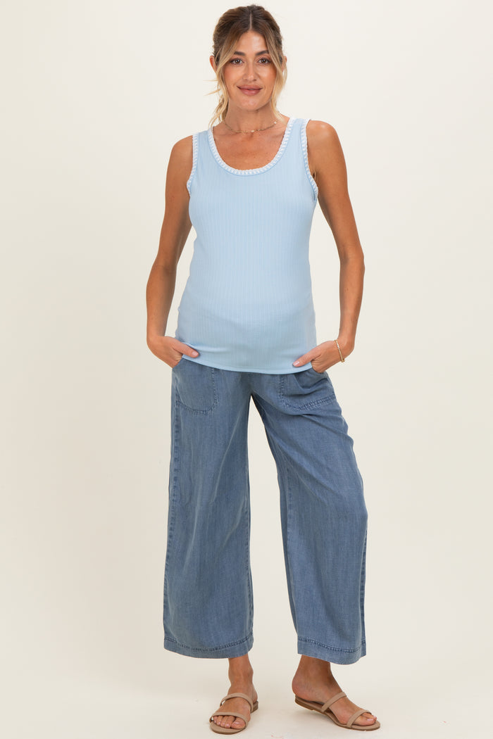 woman wearing a light blue ribbed maternity tank top and loose-fitting denim culottes
