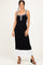 woman wearing a black and white ribbed maxi dress with a button detail and straps