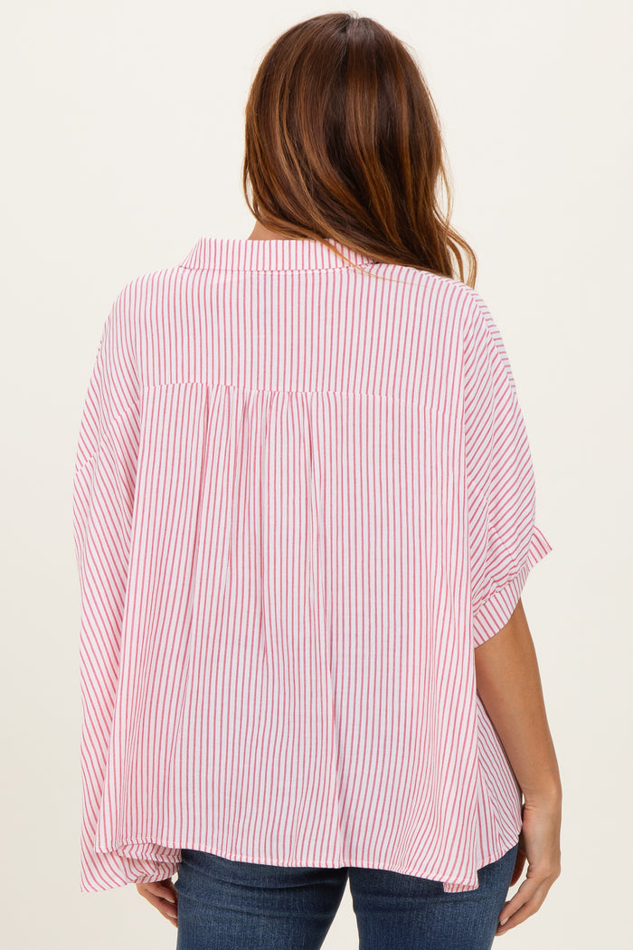 woman wearing a red and white striped oversized blouse with a pleated back and short sleeves