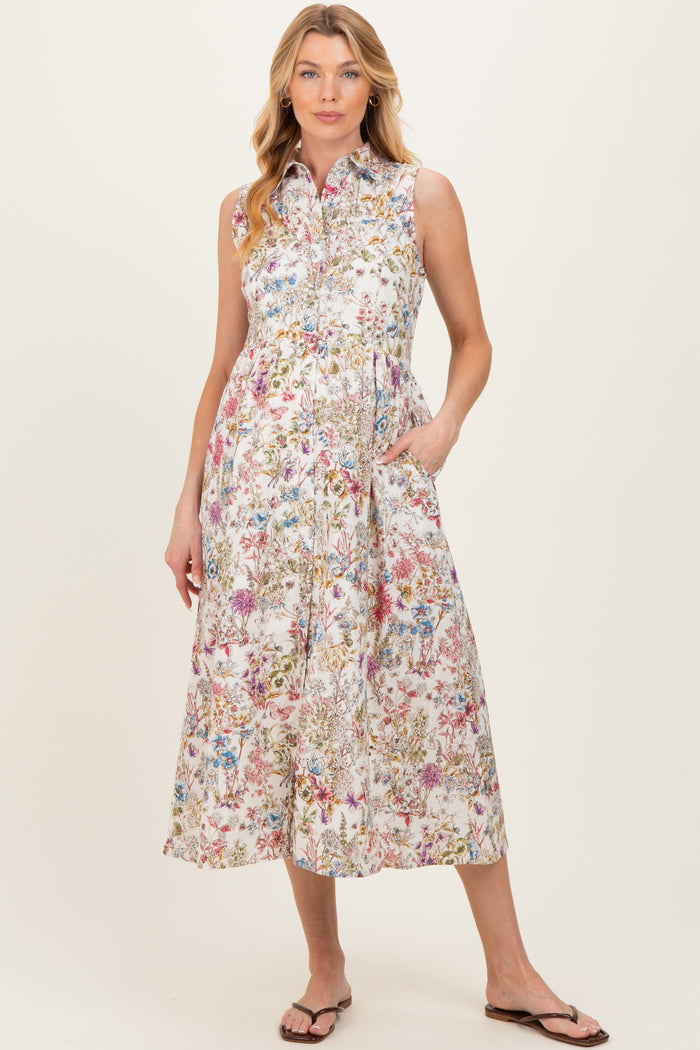 woman wearing a floral print sleeveless maternity dress with pockets and a collared neckline