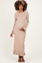 woman wearing a beige ribbed maternity dress with long sleeves, showcasing her baby bump