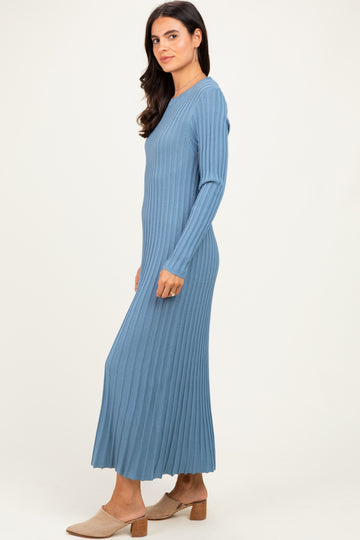 woman wearing a long sleeve light blue ribbed maxi dress with a fitted top and flowing skirt