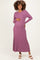 woman wearing a mauve long sleeve ribbed maternity dress, gently holding her baby bump