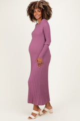 woman wearing a ribbed purple maternity maxi dress, showing her baby bump while smiling at the camera