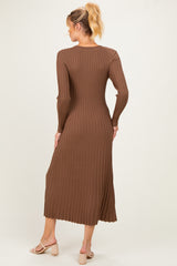 woman wearing a brown ribbed midi maternity dress with long sleeves, showing a fitted silhouette from the back
