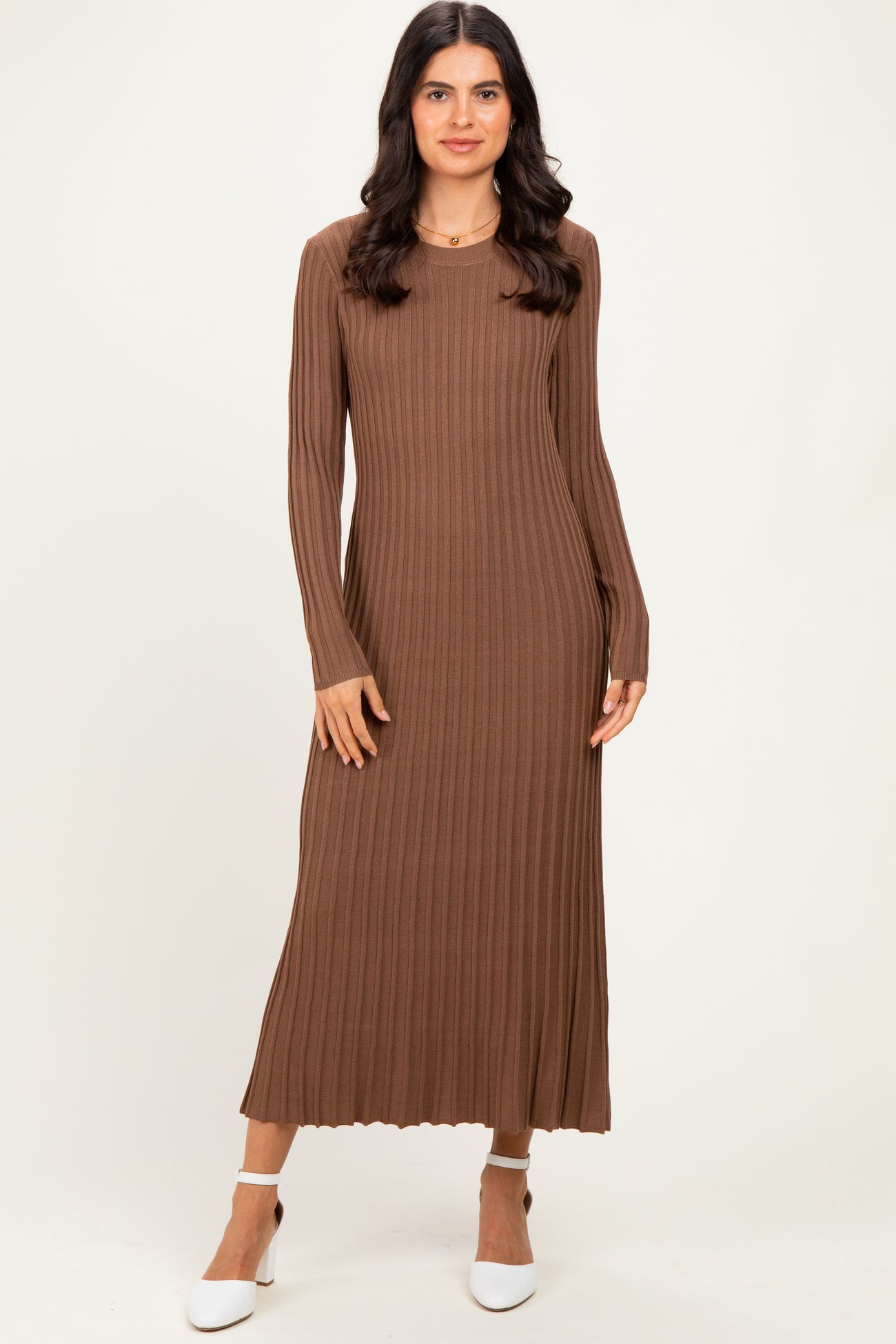 woman wearing a brown ribbed long sleeve maxi dress with a slim fit and round neckline