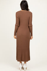 woman wearing a long brown ribbed knit dress with long sleeves, viewed from the back
