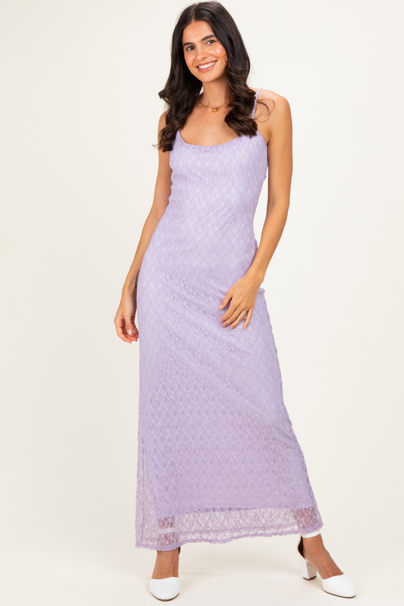 woman wearing a lavender lace maxi dress with spaghetti straps and a fitted silhouette