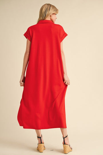 woman wearing a bright red maxi dress with short sleeves and a relaxed fit, showing the back view
