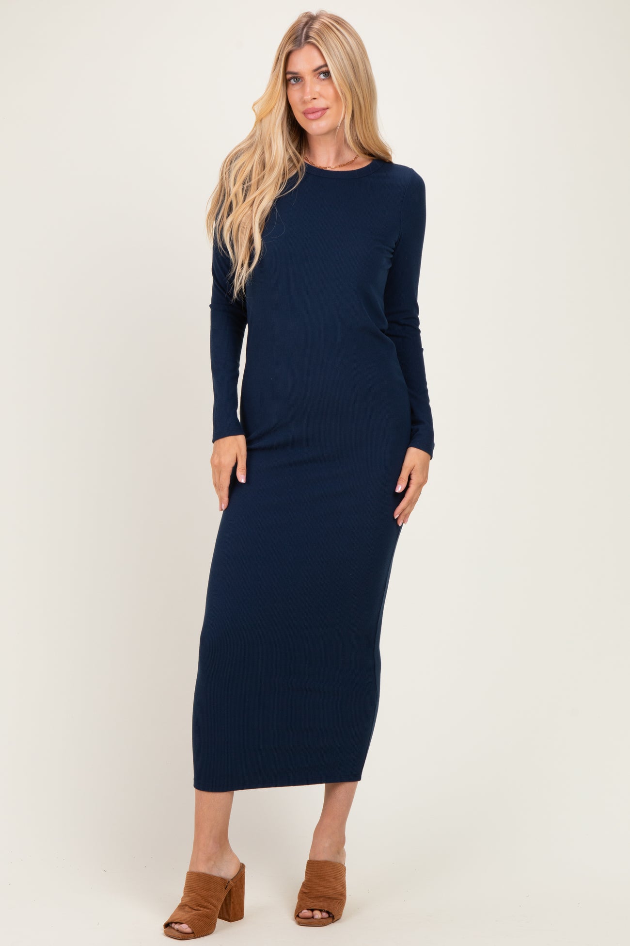 woman wearing a navy ribbed long sleeve maxi dress and brown heeled sandals