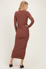 woman wearing a brown ribbed long sleeve maxi dress, showing the back view with fitted silhouette and side slit details