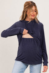 woman wearing a navy blue maternity hoodie with a front opening, showing her baby bump