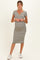 woman wearing a striped maternity dress with a v-neckline and short sleeves, showing her baby bump
