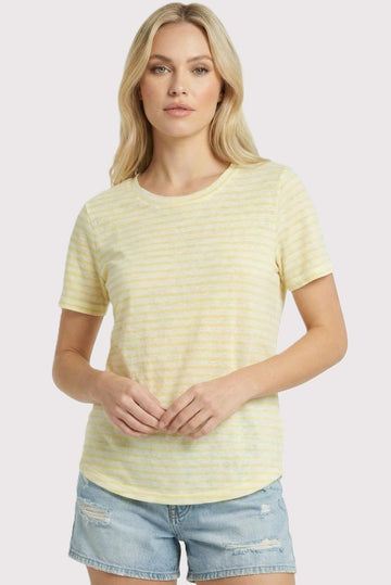 woman wearing a yellow and white striped short sleeve t-shirt with a relaxed fit and light blue denim shorts