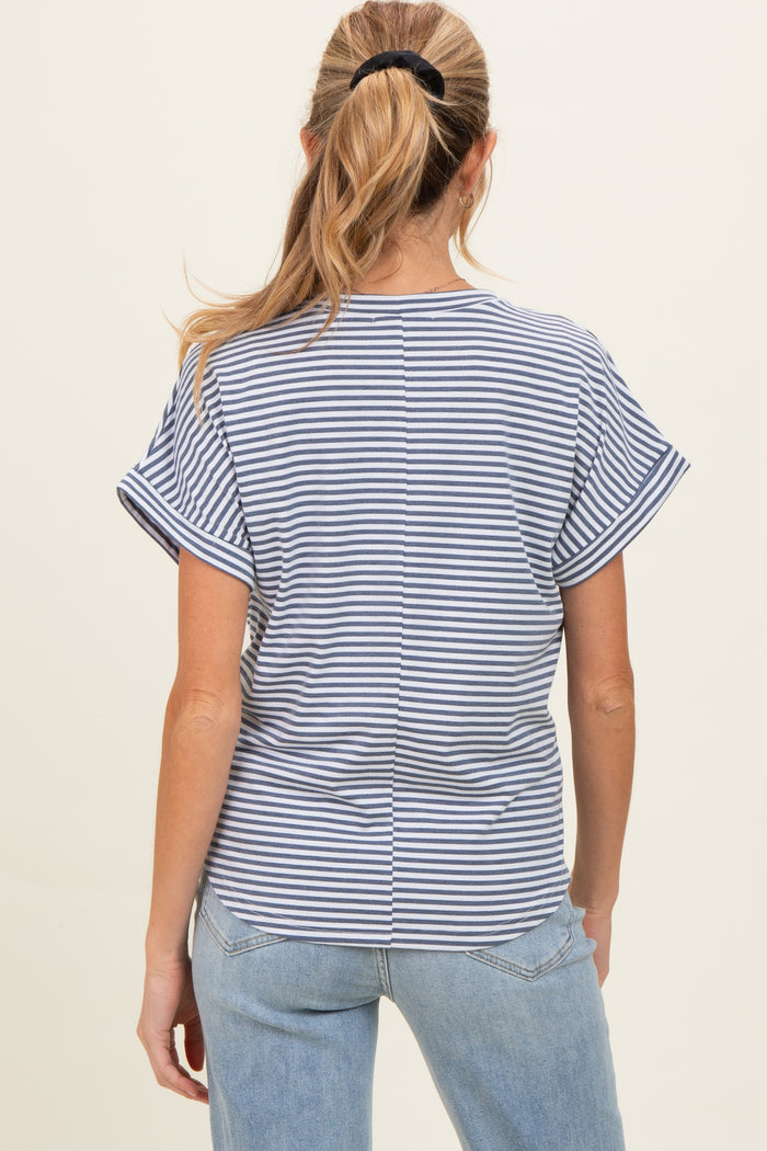 woman wearing a navy and white striped short sleeve maternity top, seen from the back with casual jeans