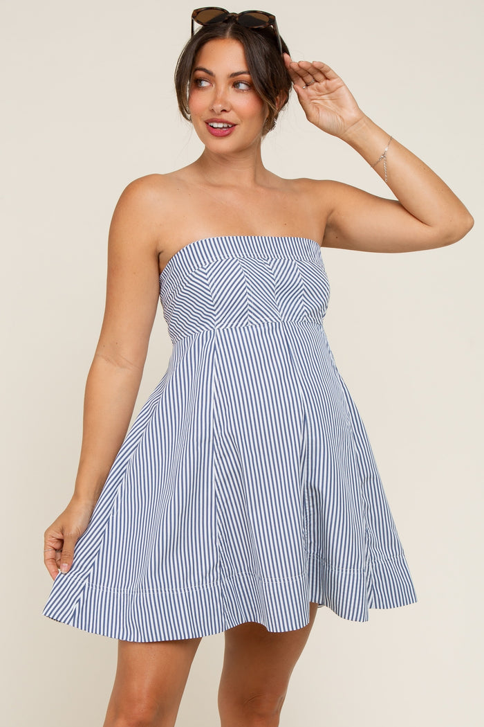 woman wearing a navy and white striped strapless maternity dress with a flared skirt and visible baby bump