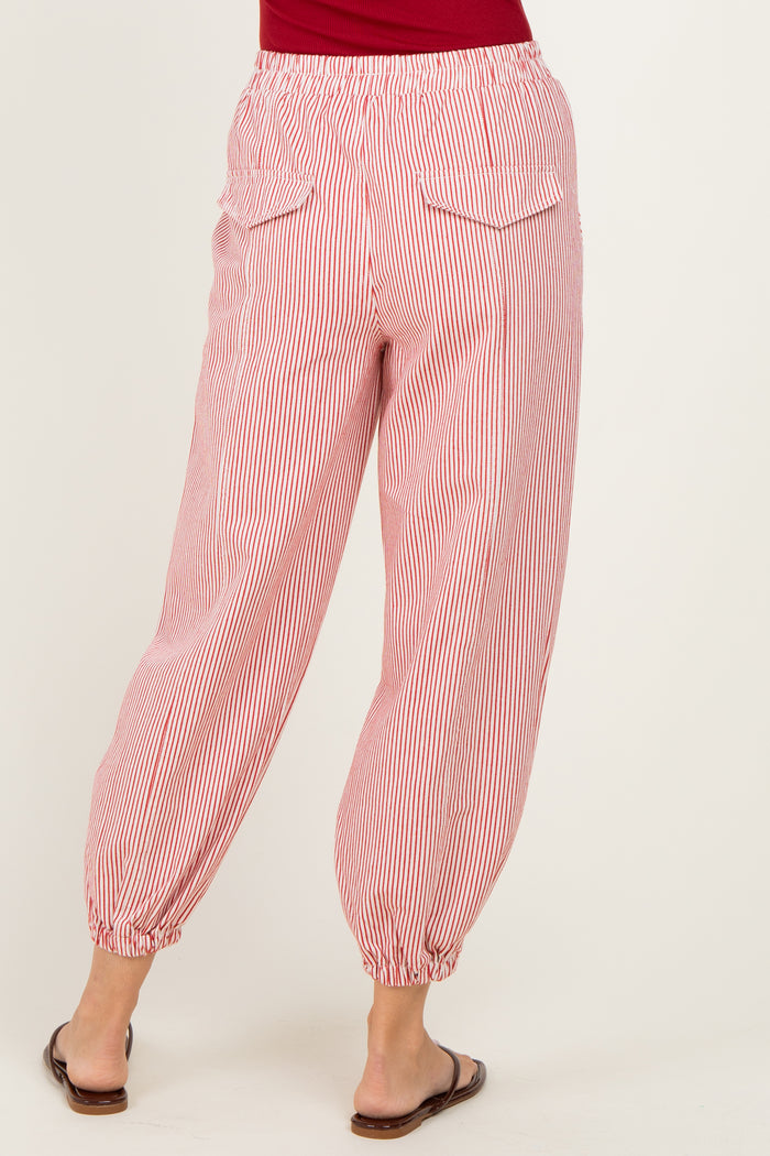 woman wearing red and white striped loose-fitting pants with elastic cuffs and back pockets