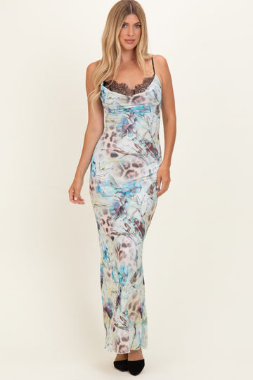 woman wearing a fitted maxi dress with a colorful floral print and lace detailing at the neckline
