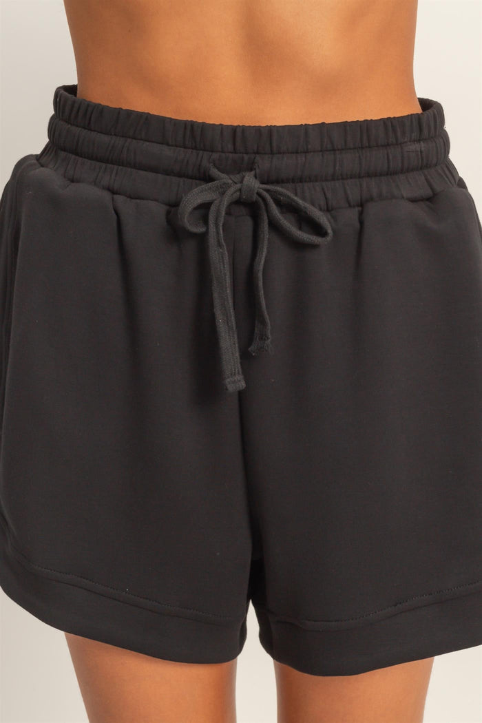 black elastic waist shorts with drawstring detail and relaxed fit