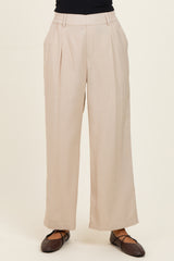 woman wearing beige wide-leg trousers with a high waist and side pockets