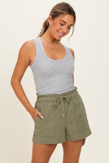 woman wearing a gray ribbed tank top and olive green high-waisted shorts with buttons and pockets