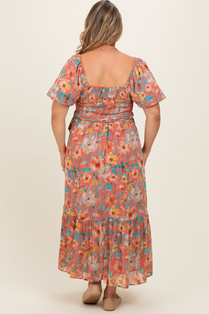 woman wearing a floral printed maternity plus maxi dress with a smocked bodice and flutter sleeves, viewed from the back