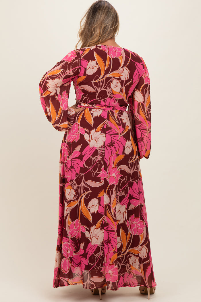 woman wearing a floral print maternity plus maxi dress with long sleeves and a tie waist, showing the back view