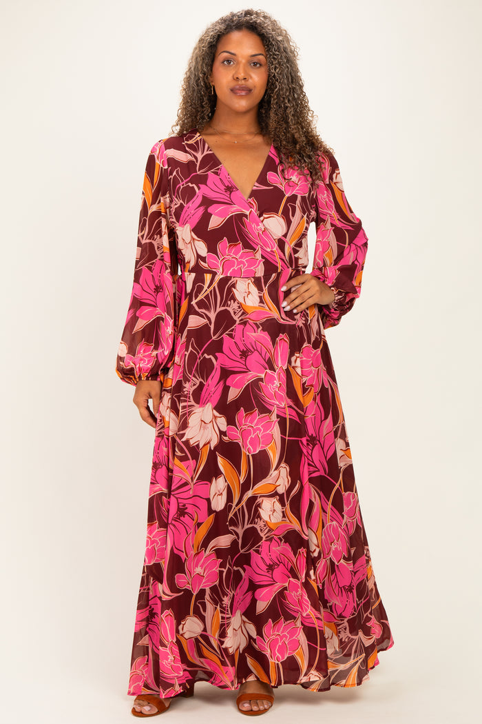 woman wearing a long purple floral plus-size maxi dress with long sleeves and a wrap style