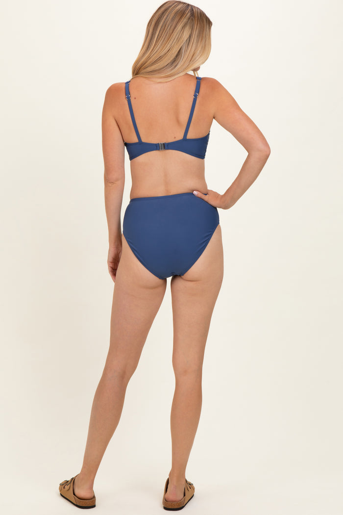 woman wearing a blue bikini set with a bralette top and high-waisted bottom, viewed from the back