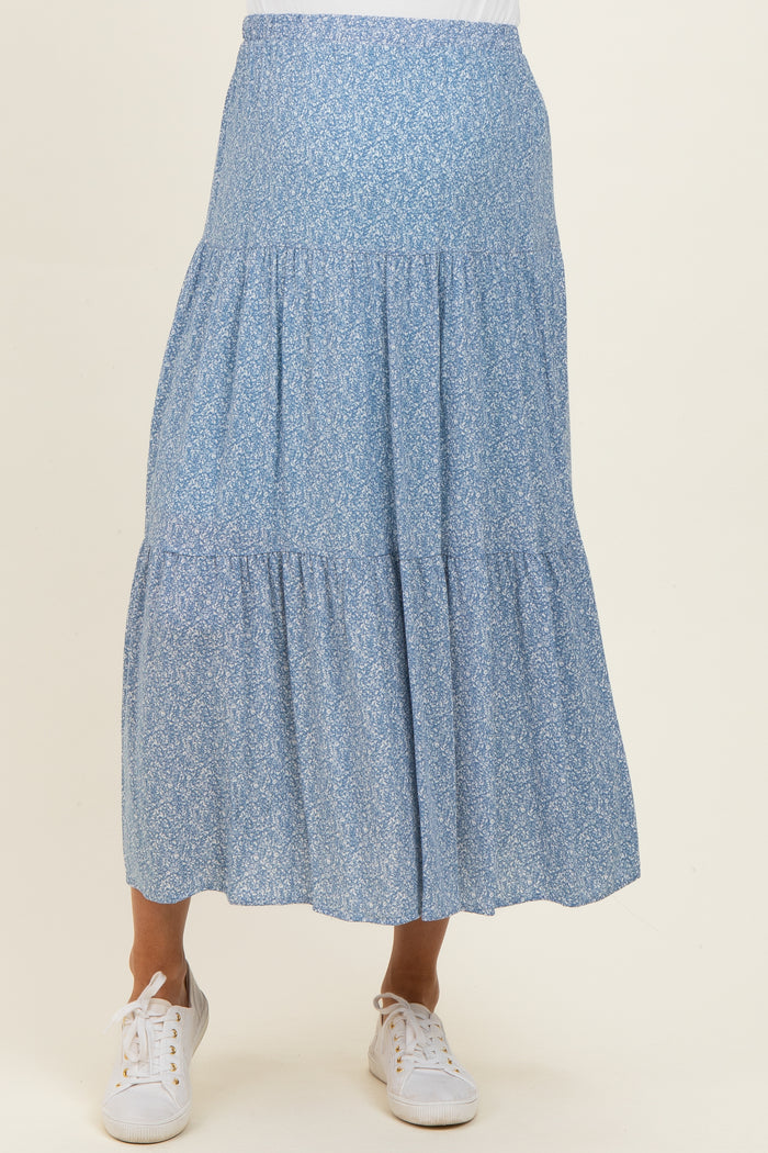 woman wearing a light blue floral maternity skirt with a tiered design and elastic waistband