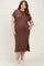 woman wearing a brown short sleeve maternity dress with pockets and a side slit, showing her baby bump