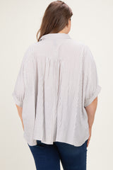 back view of a woman wearing a striped maternity plus size blouse with short sleeves and a relaxed fit