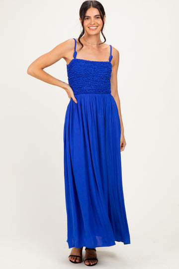 woman wearing a vibrant blue maxi dress with a smocked bodice and thin straps