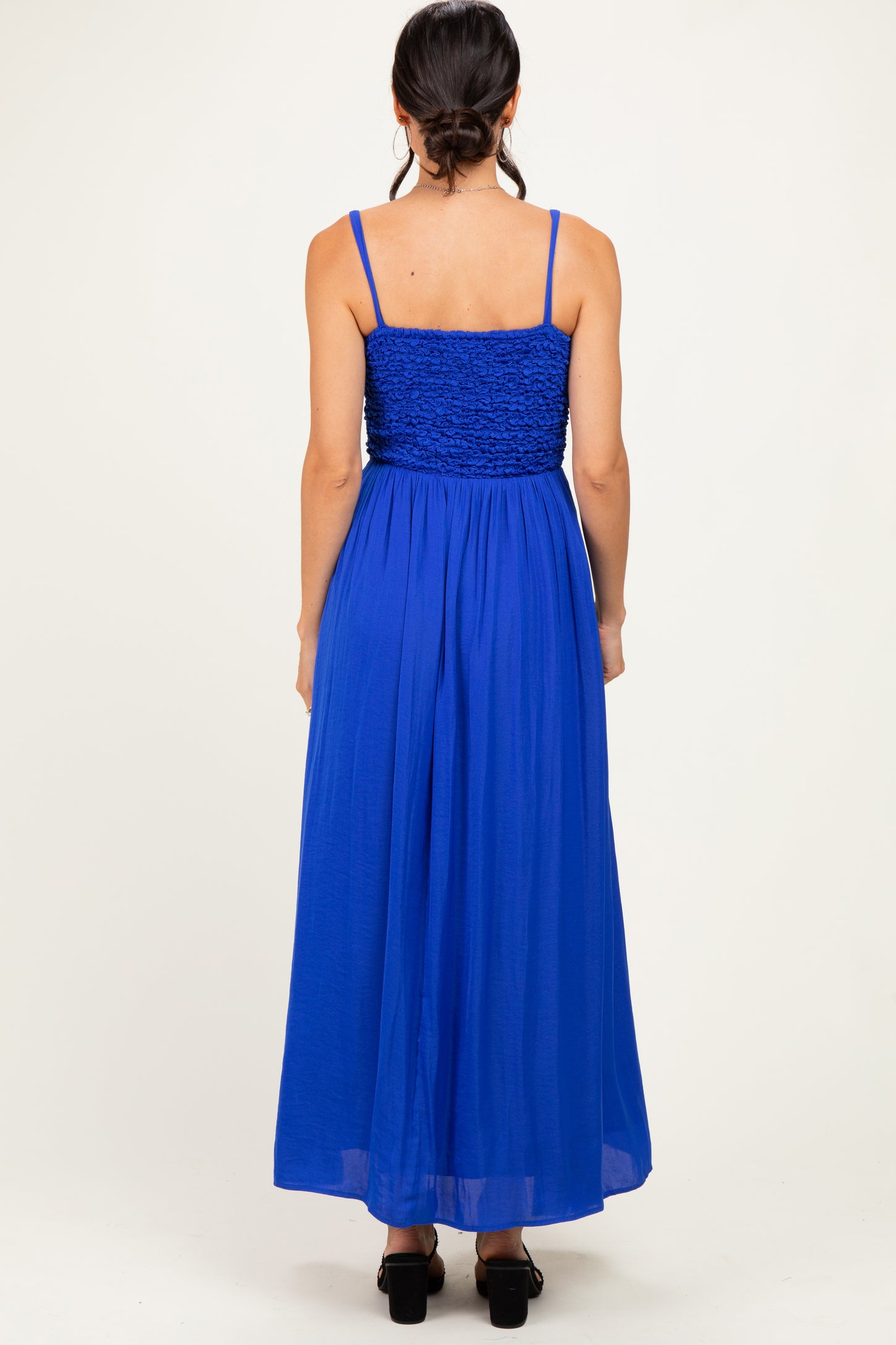 woman wearing a blue back view maxi dress with smocked bodice and adjustable straps