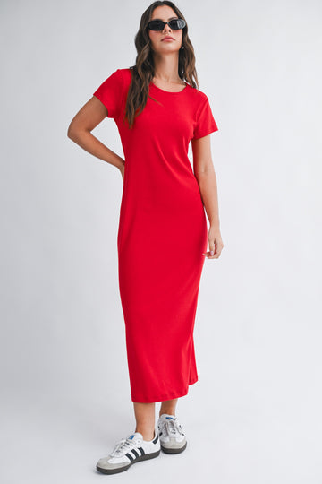 woman wearing a red short sleeve maxi dress and black sunglasses, paired with white and black sneakers