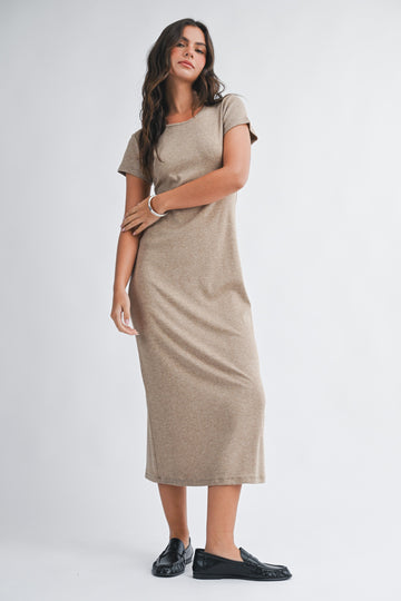woman wearing a taupe short sleeve midi dress with a relaxed fit and black loafers