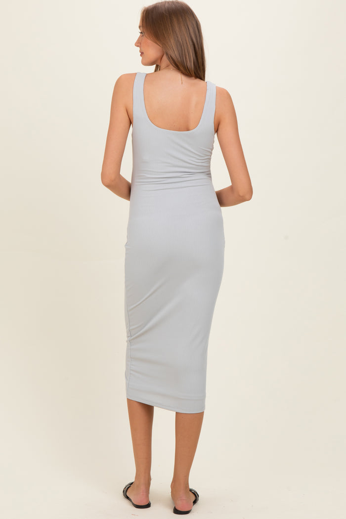 woman wearing a light gray ribbed maternity midi dress, showing the back and form-fitting silhouette