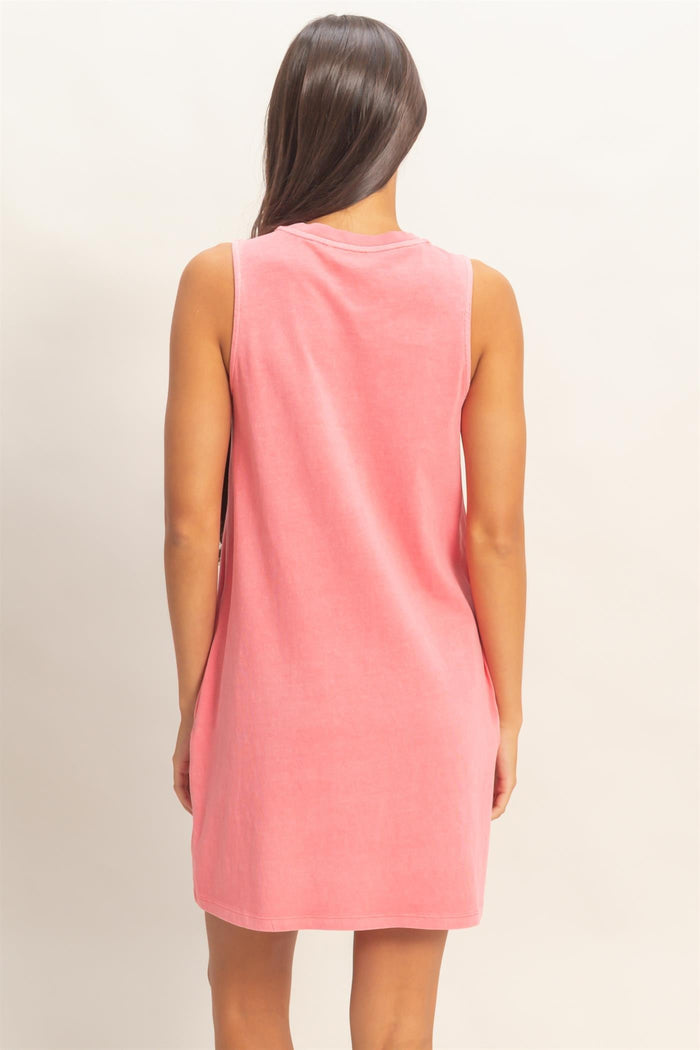 woman wearing a sleeveless pink terry cloth dress, view from the back