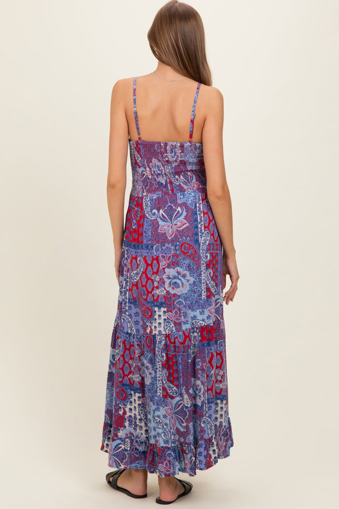woman wearing a blue and purple patterned maternity maxi dress with spaghetti straps and a flowy hemline