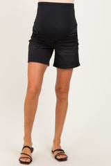 maternity wear black denim maternity shorts with a supportive belly band, model wearing sandals